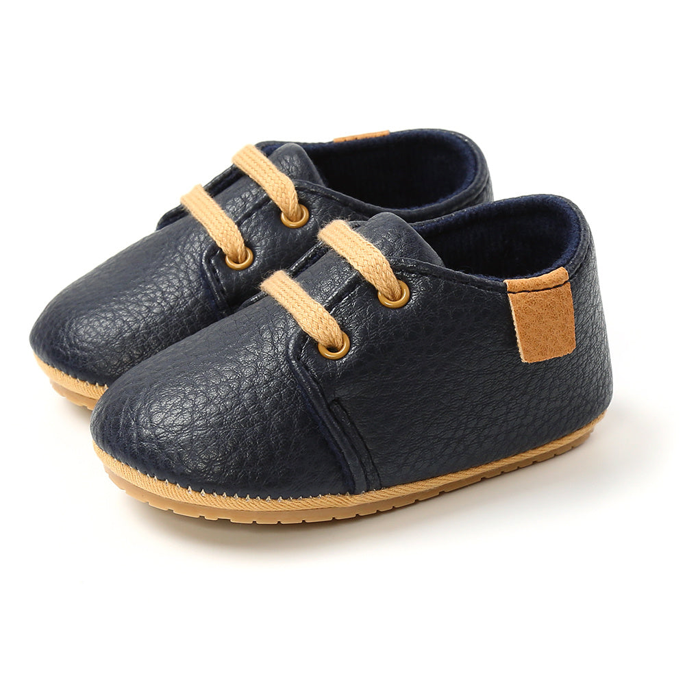 Top-down view of baby boy and girl sneakers