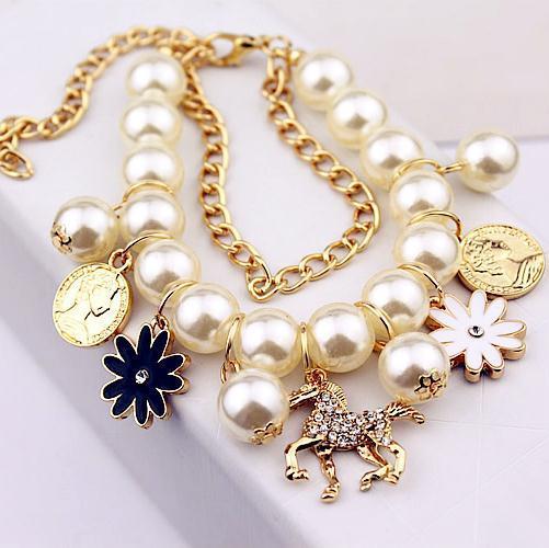 Close-up of faux pearls and floral accents