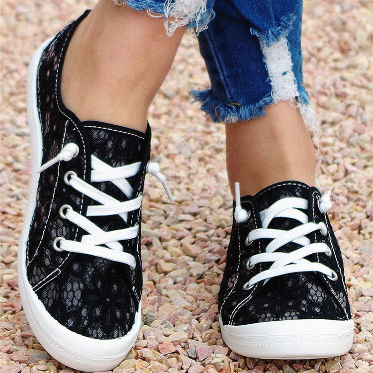 Close-up of floral lace detailing on casual flats