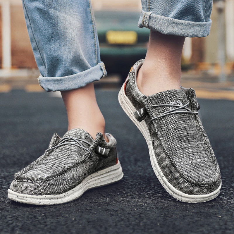 Man wearing fashion canvas loafers with rolled jeans