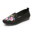 Woman wearing lightweight embroidered cloth shoes on sidewalk

