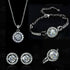 Silver jewelry set with intricate design on black velvet


