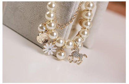Dainty flower bracelet worn by female model

