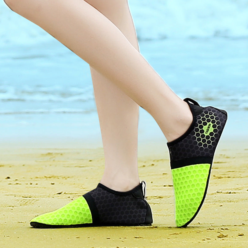 Man walking on rocks wearing non-slip beach shoes


