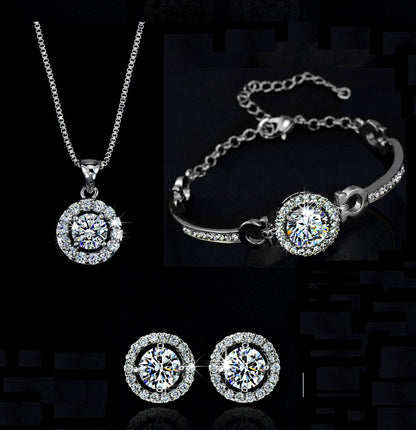 Gold necklace, earrings, and bracelet set displayed on white background

